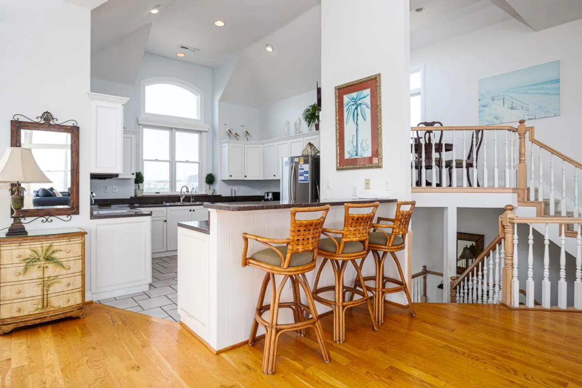 A bright open-plan kitchen and dining area with a breakfast bar.