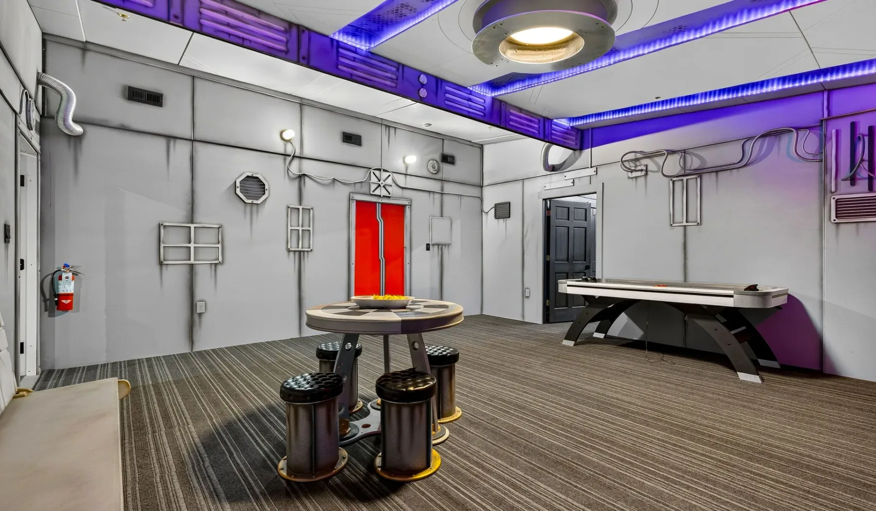 A futuristic-looking room with round seating and a long table.