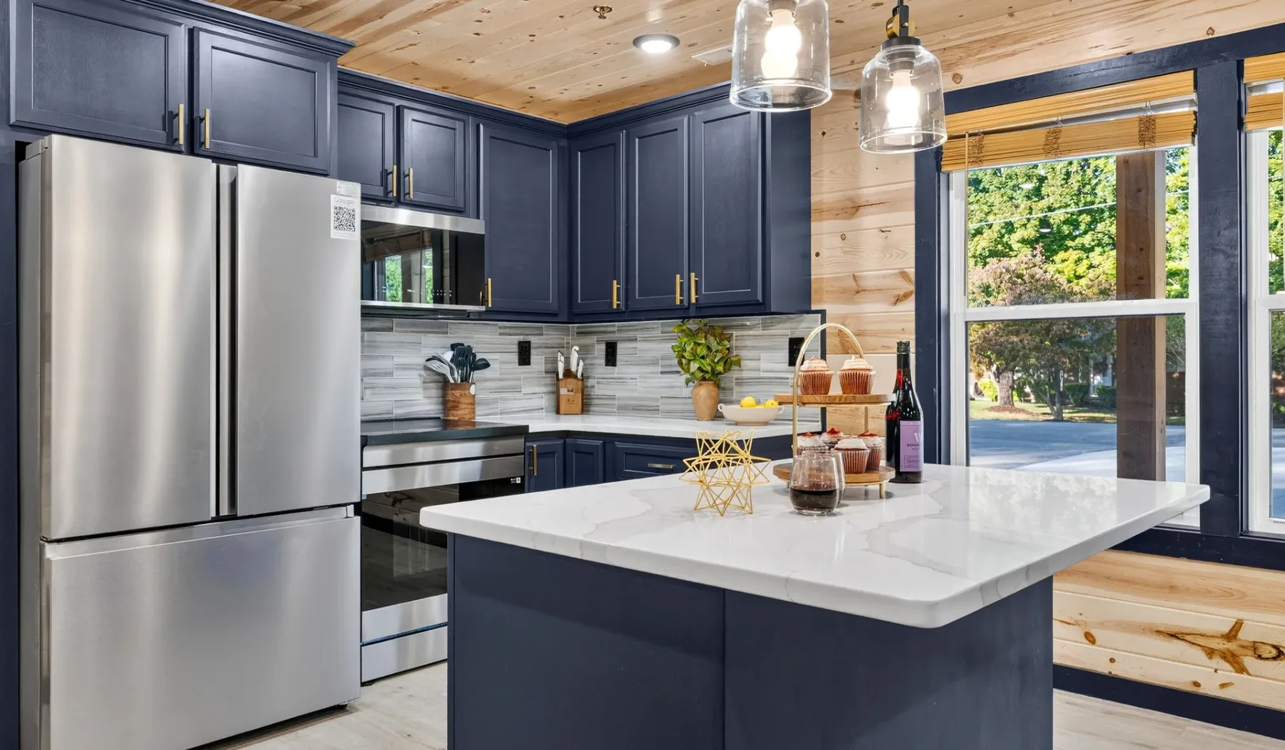 A modern kitchen with dark cabinets and a large central island.