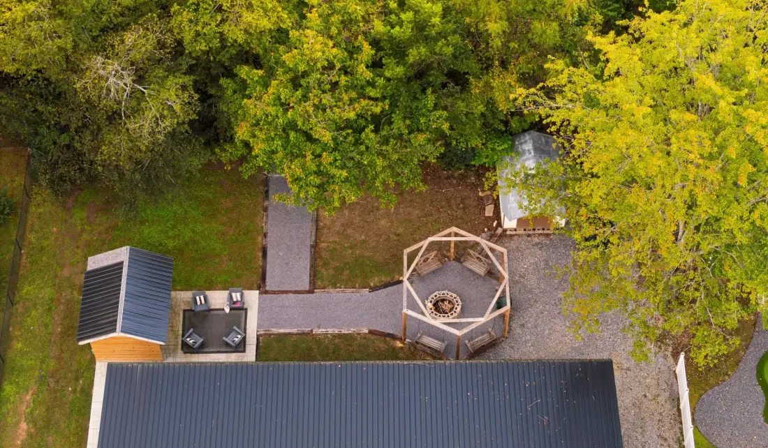 An aerial view of a wooded outdoor area with a small deck and walkway.