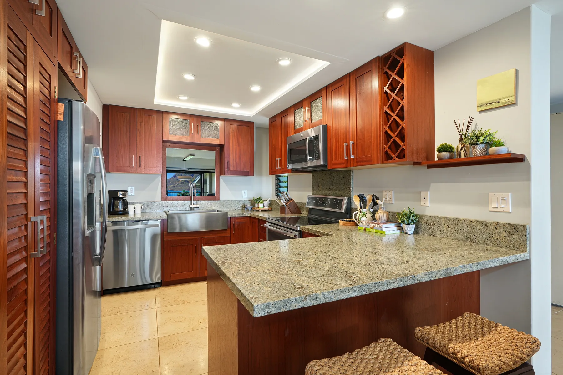 A spacious kitchen with wooden cabinets, stainless steel appliances, and a large island.
