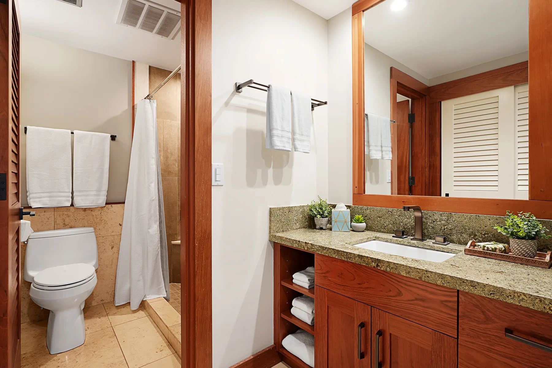 A bathroom with a vanity, sink, and towel rack.