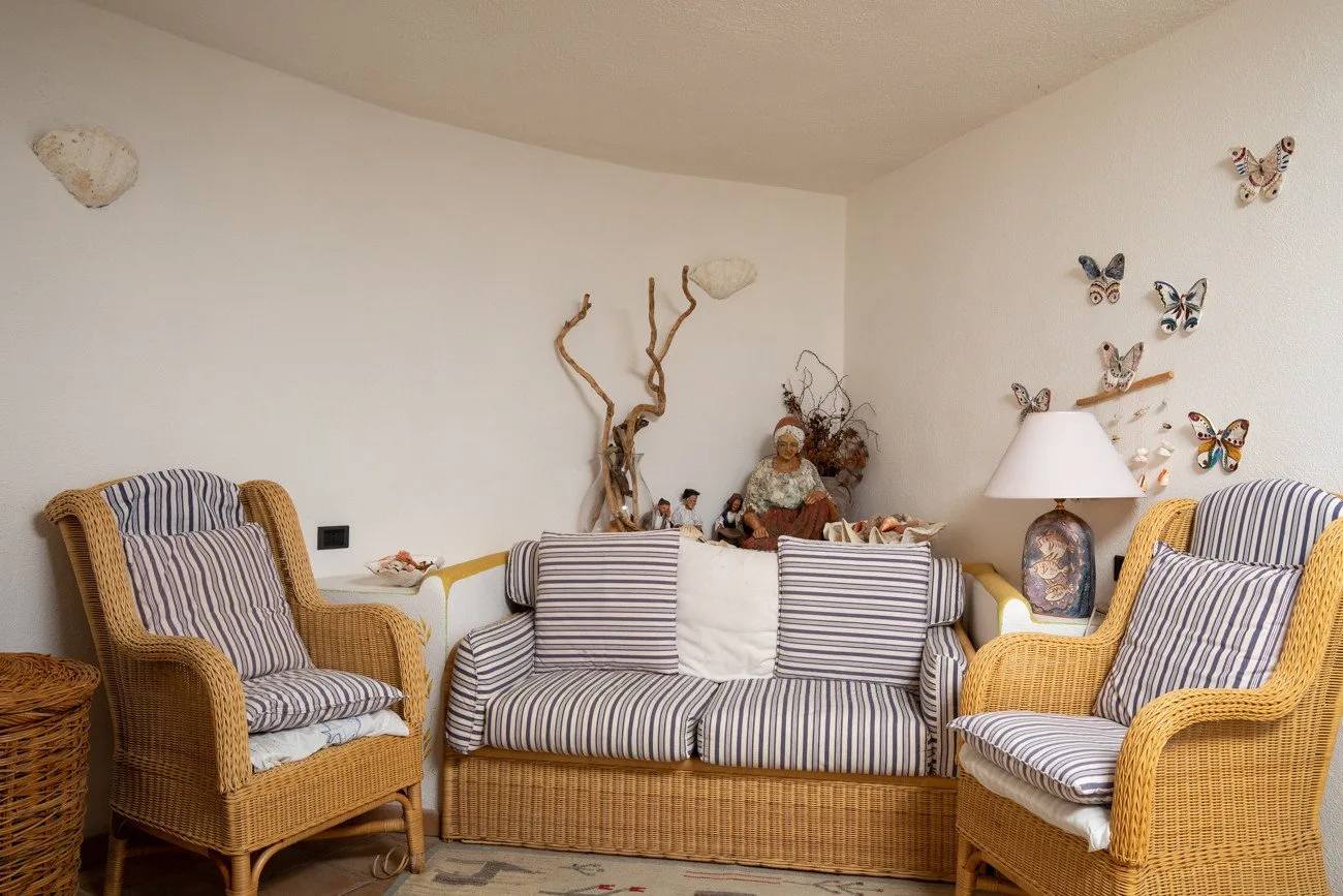 A sitting area with striped seating and butterfly decorations on the wall.