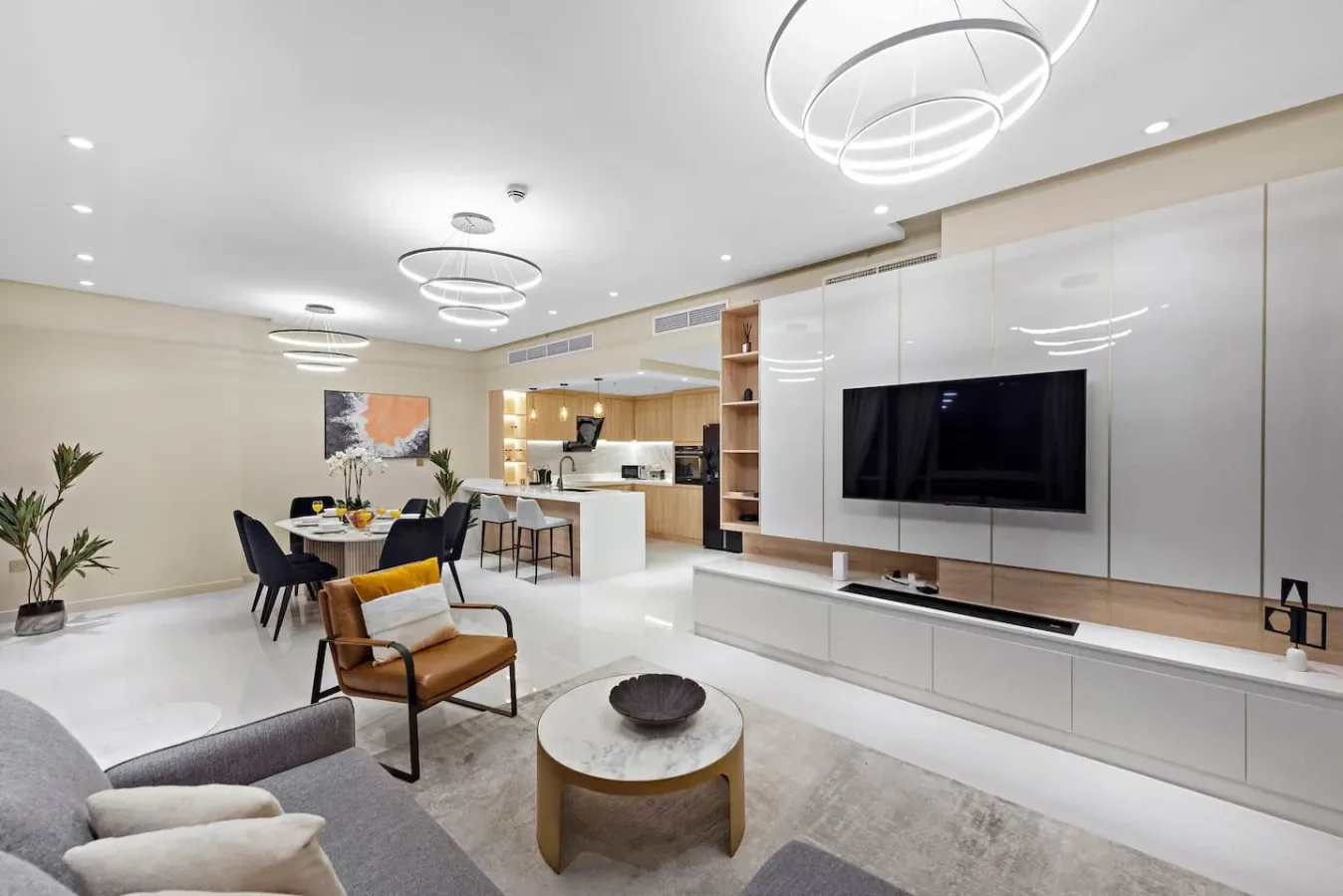An open-plan living and dining area with a television and kitchen.