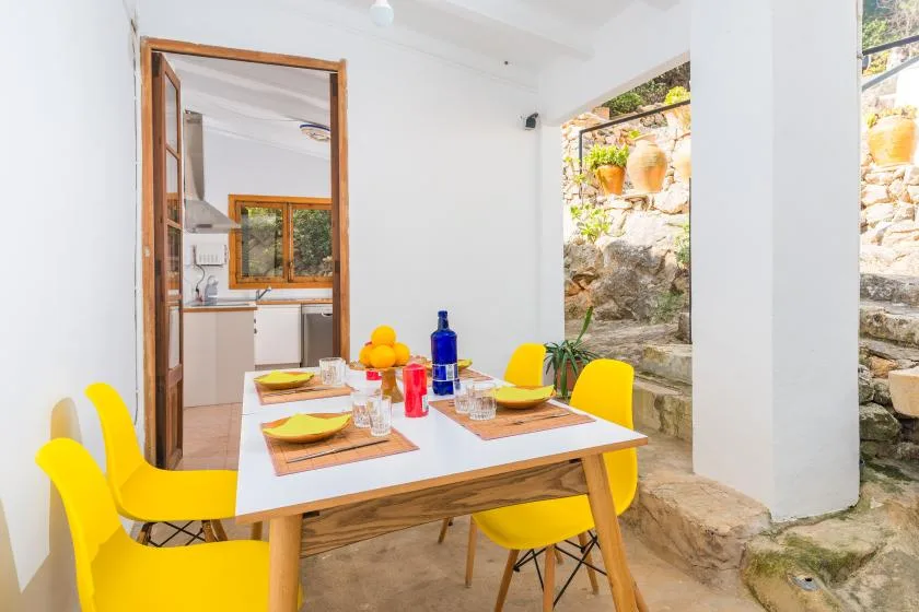 A dining area with a table set with dishes and bright yellow seating.