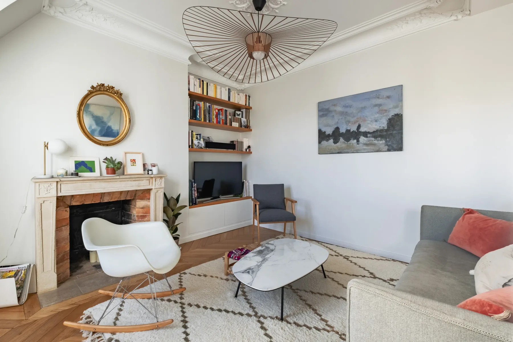 Living room with a fireplace, seating, and a television.