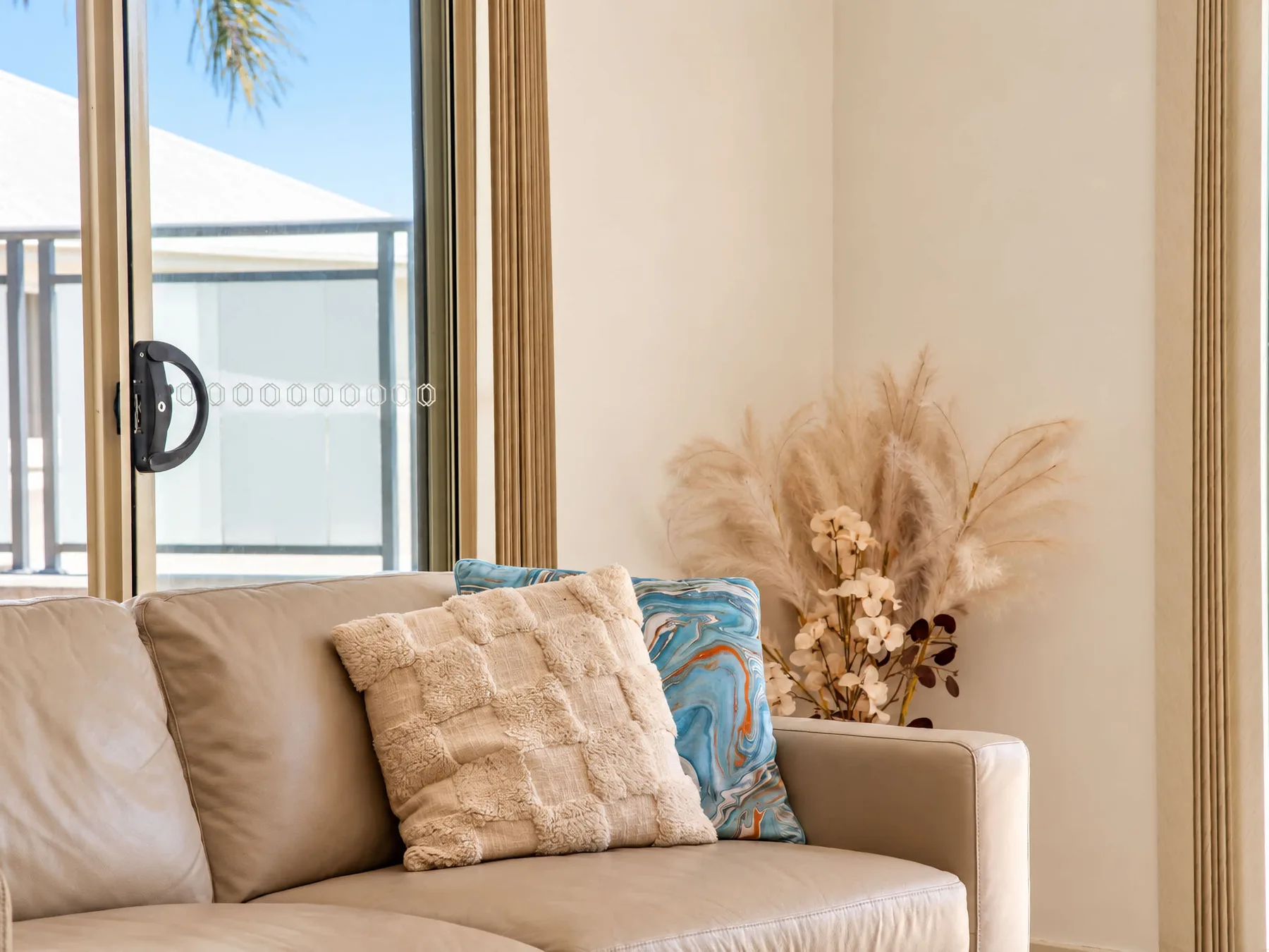 A living room with seating beside a large window.