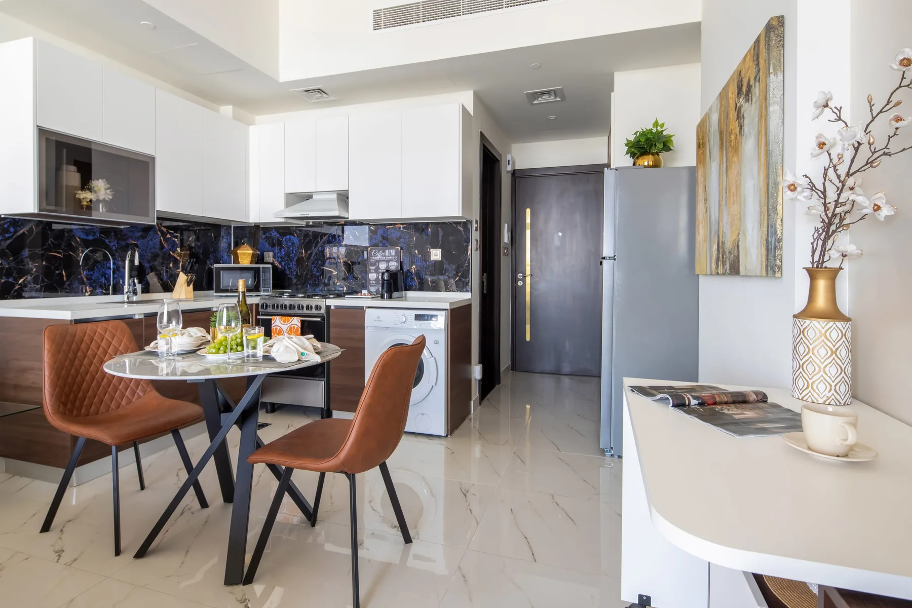 A bright kitchen and dining area with a table beside the counter.