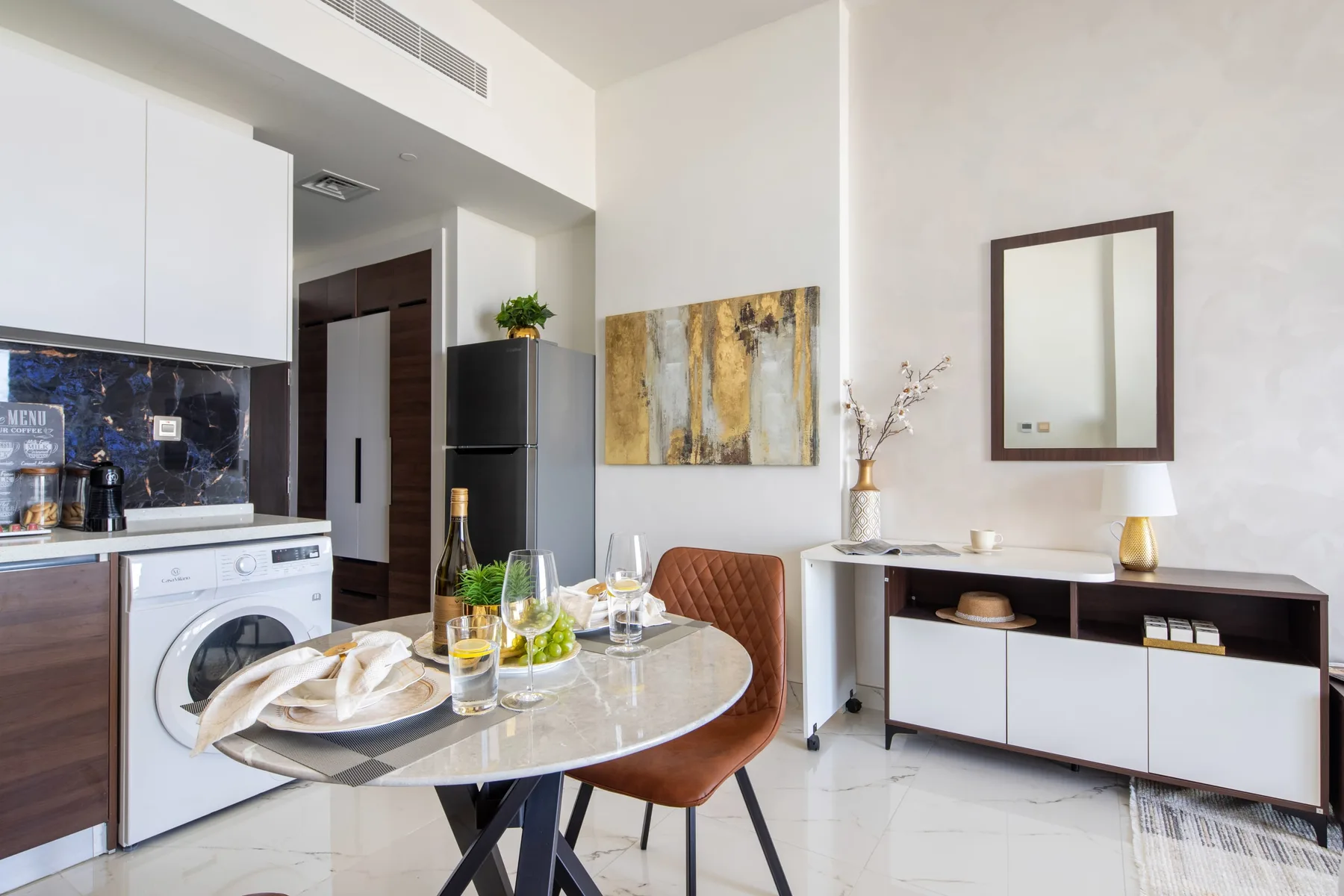 A bright dining area with a table and chairs beside the kitchen.