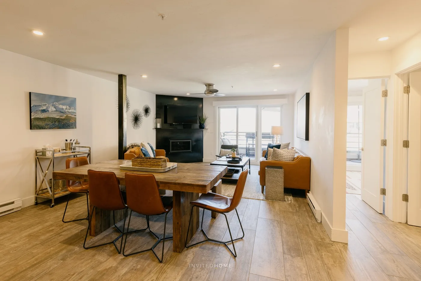 An open-plan living and dining area with a wooden table and seating.
