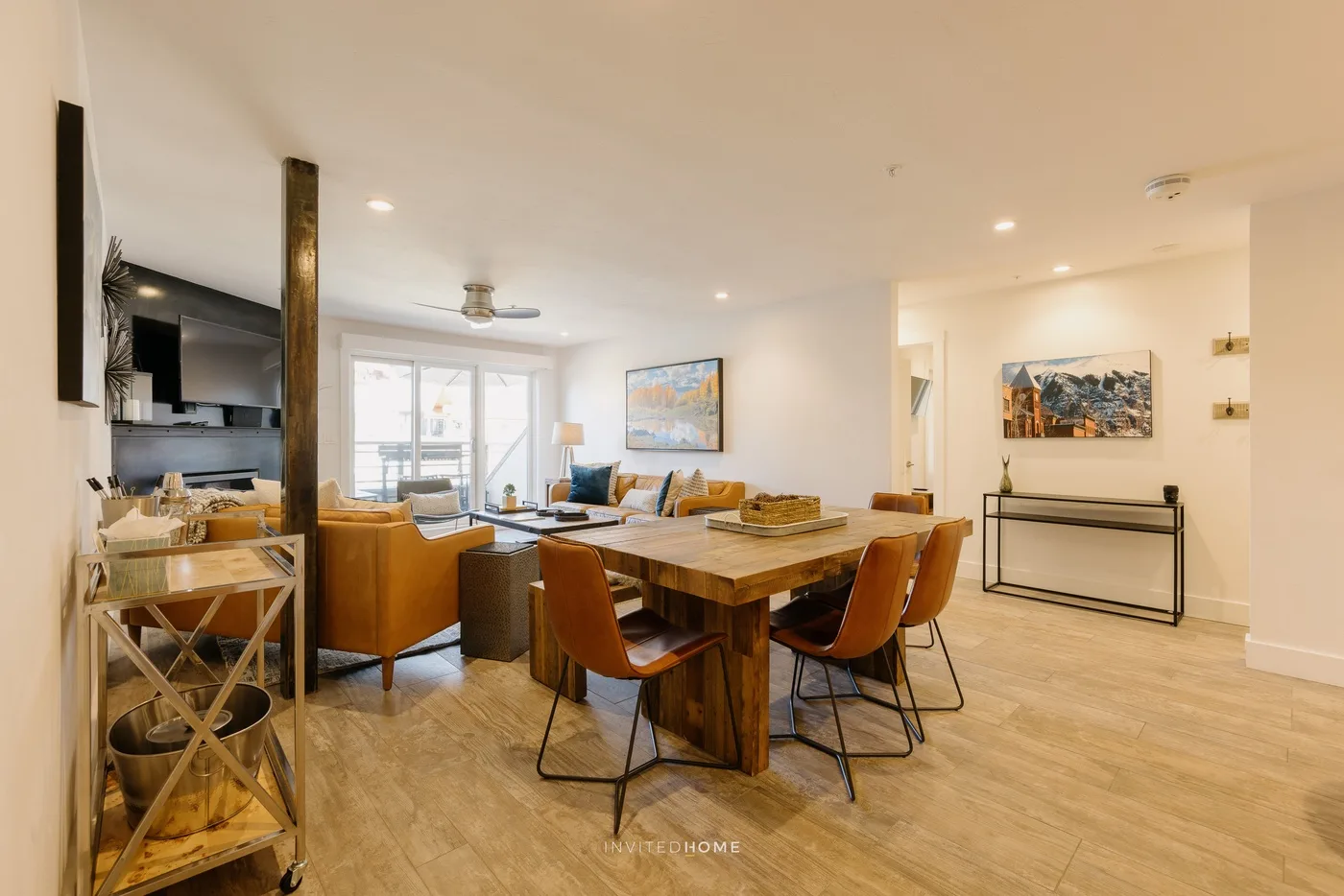Open-plan living and dining area with a wooden table and seating.