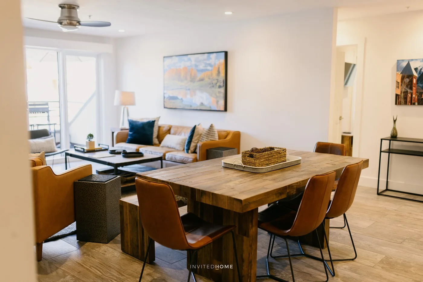 An open-plan living and dining area with a wooden dining table and seating.