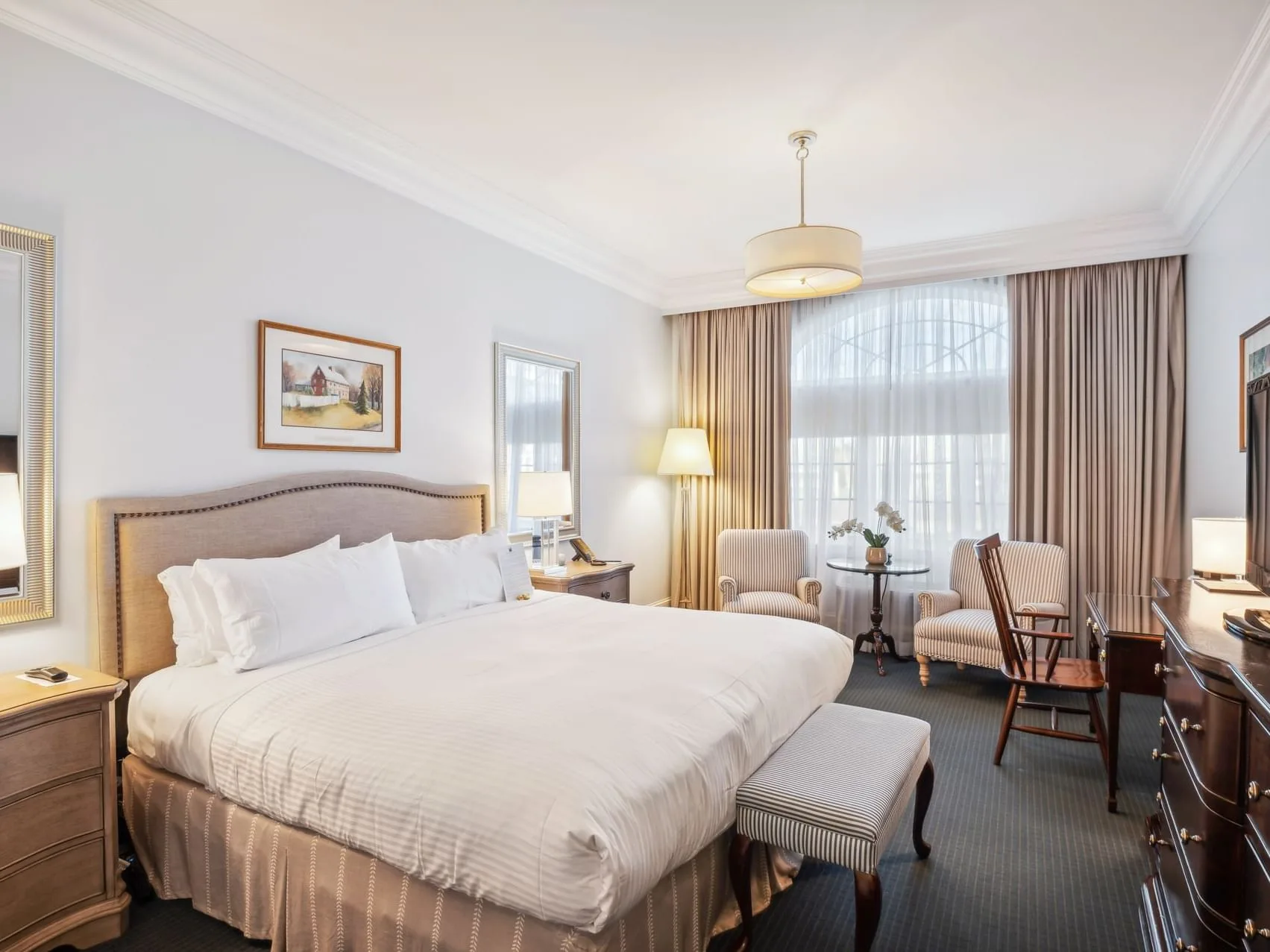 Luxury King room with bed, desk, and seating
