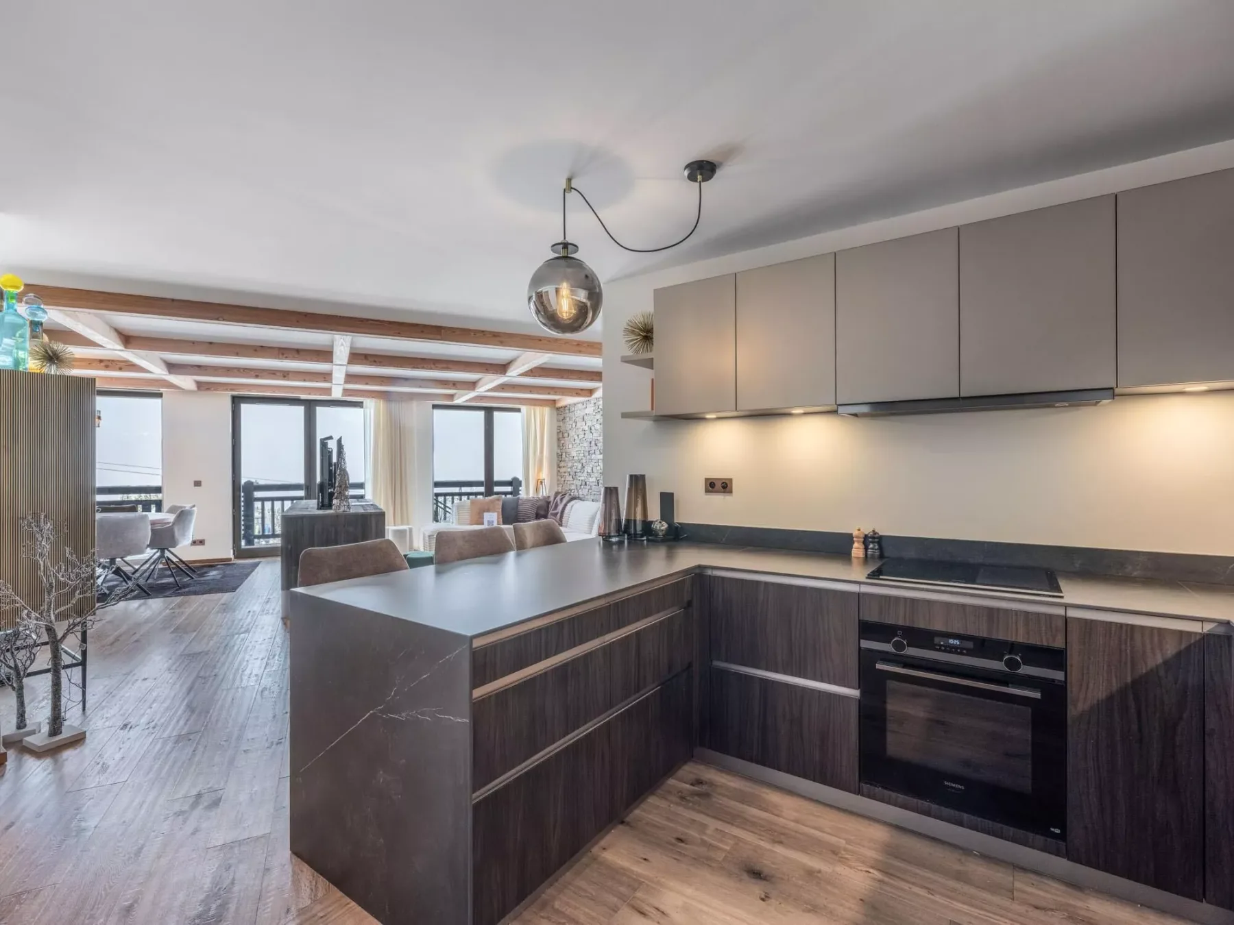 An open-plan kitchen and living area with a large island and dining table.