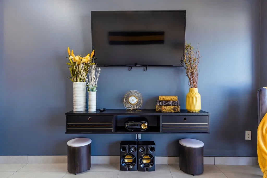 Modern entertainment setup with sleek TV, stylish console, and premium sound system—your perfect spot to unwind with movies or music after a day of exploring.