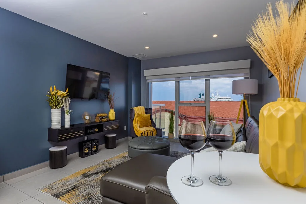 Unwind in your modern living room with stylish decor, a smart TV, and a balcony overlooking the terracotta rooftops—perfect for sipping wine after a day of exploring.