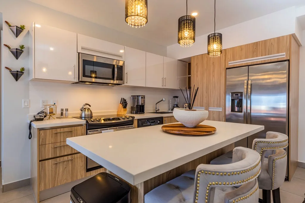 Step into your fully-equipped kitchen featuring sleek stainless steel appliances, modern cabinetry, and stylish pendant lighting. Prepare meals at the spacious island while gathering with loved ones in this inviting culinary space.