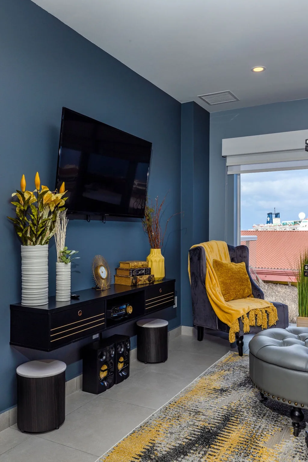 Stylish living space with bold blue walls, modern entertainment setup, and cozy seating where you can unwind after exploring the area.
