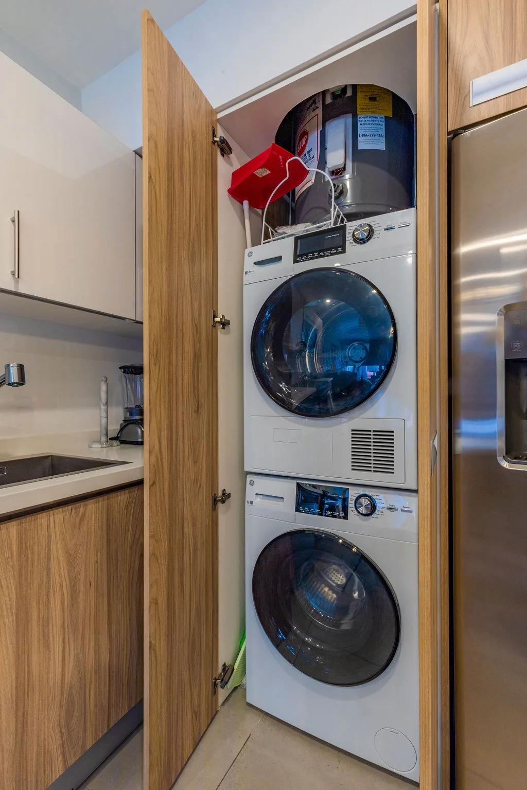 Keep your wardrobe fresh with in-unit laundry—washer and dryer stacked neatly in a cabinet, making it easy to pack light and stay comfortable during your stay.