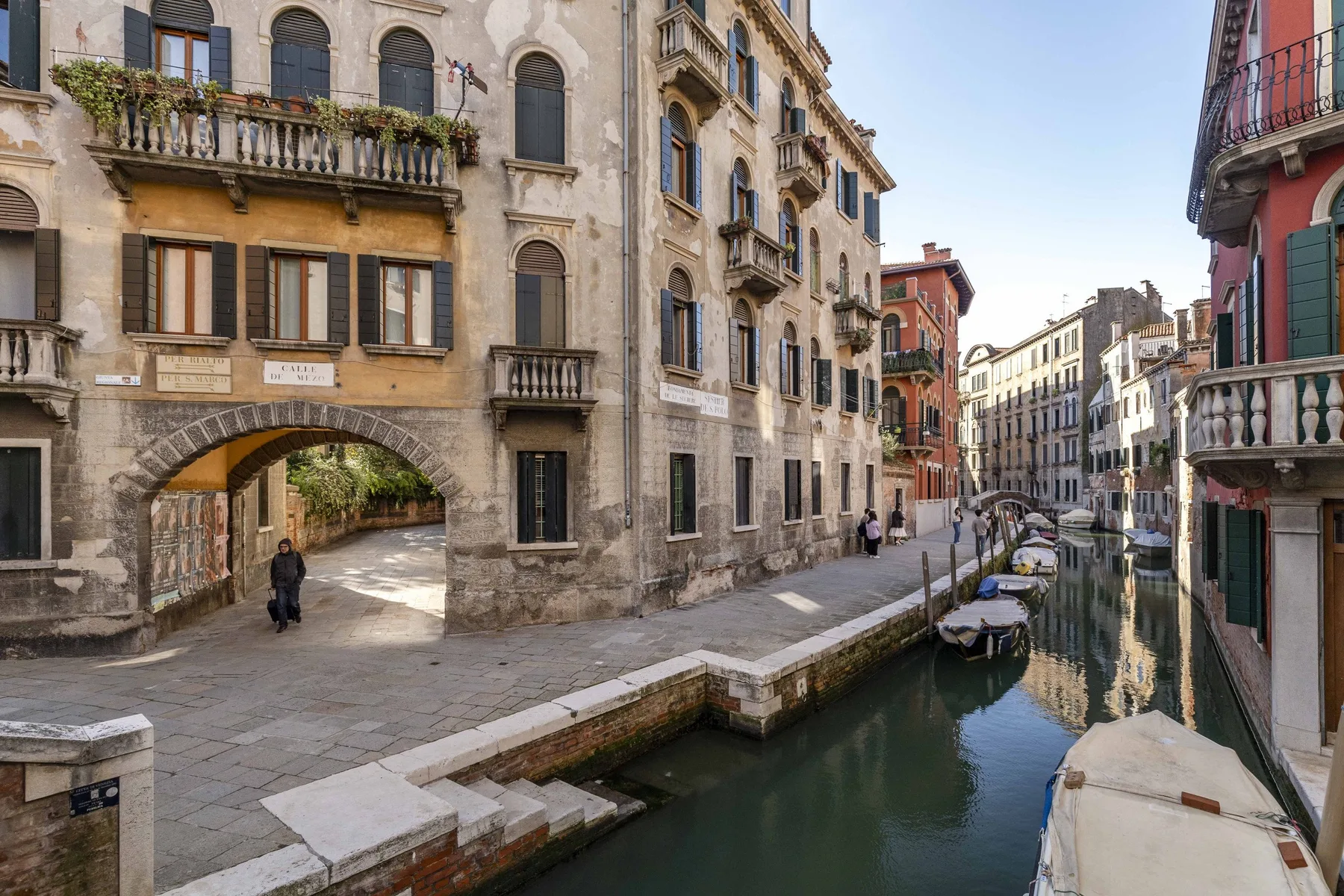 Un canal pasa entre edificios históricos junto a un paseo de piedra.