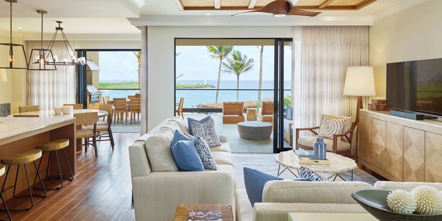 Una luminosa sala de estar y comedor de planta abierta da a un patio con vistas al agua.
