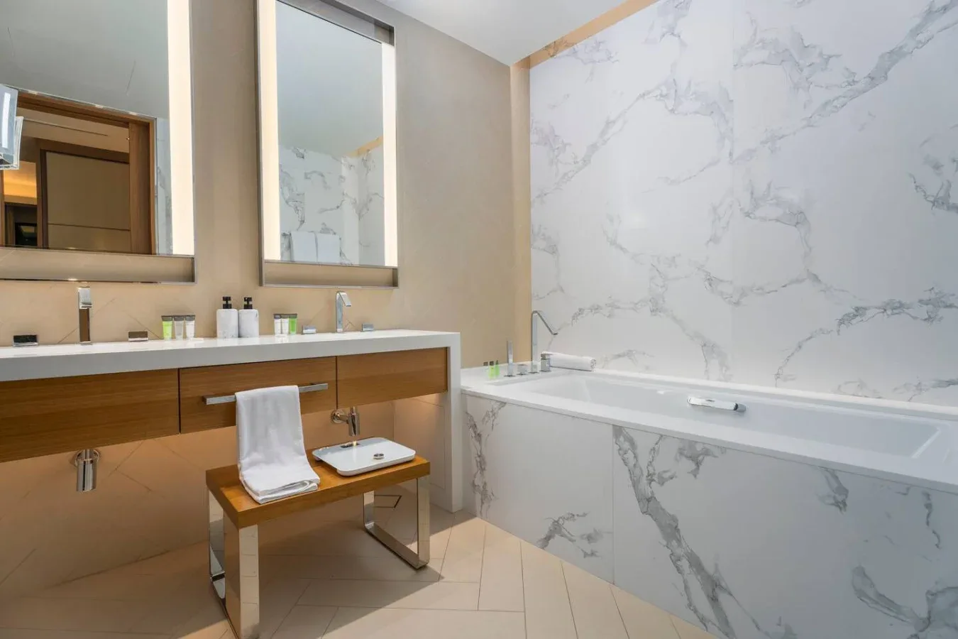 A bathroom with a long vanity beside a bathtub.