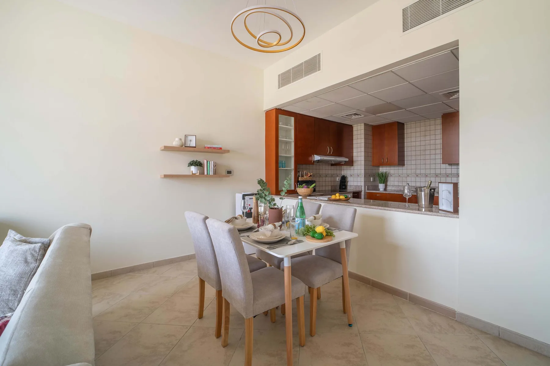 A dining area with a table and chairs beside an open kitchen.