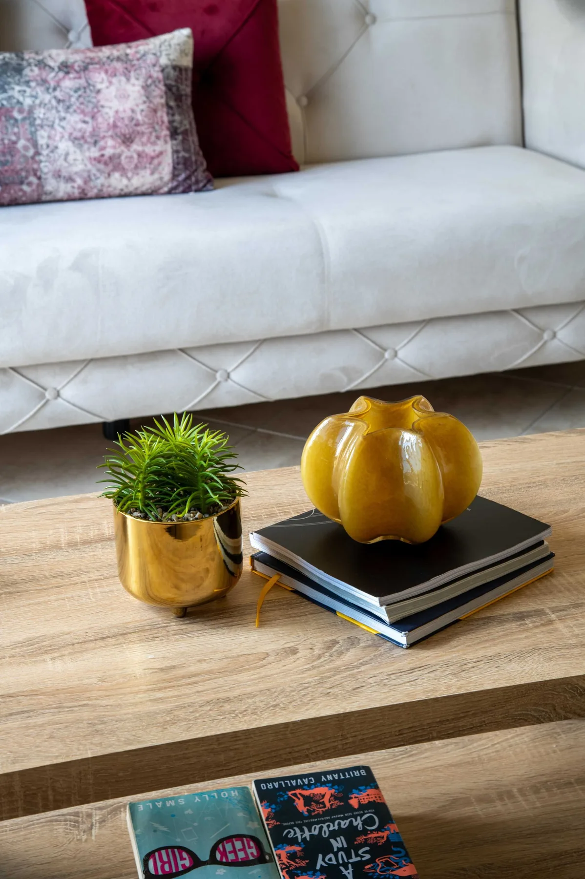 A living room seating area with a light sofa and a wooden coffee table.
