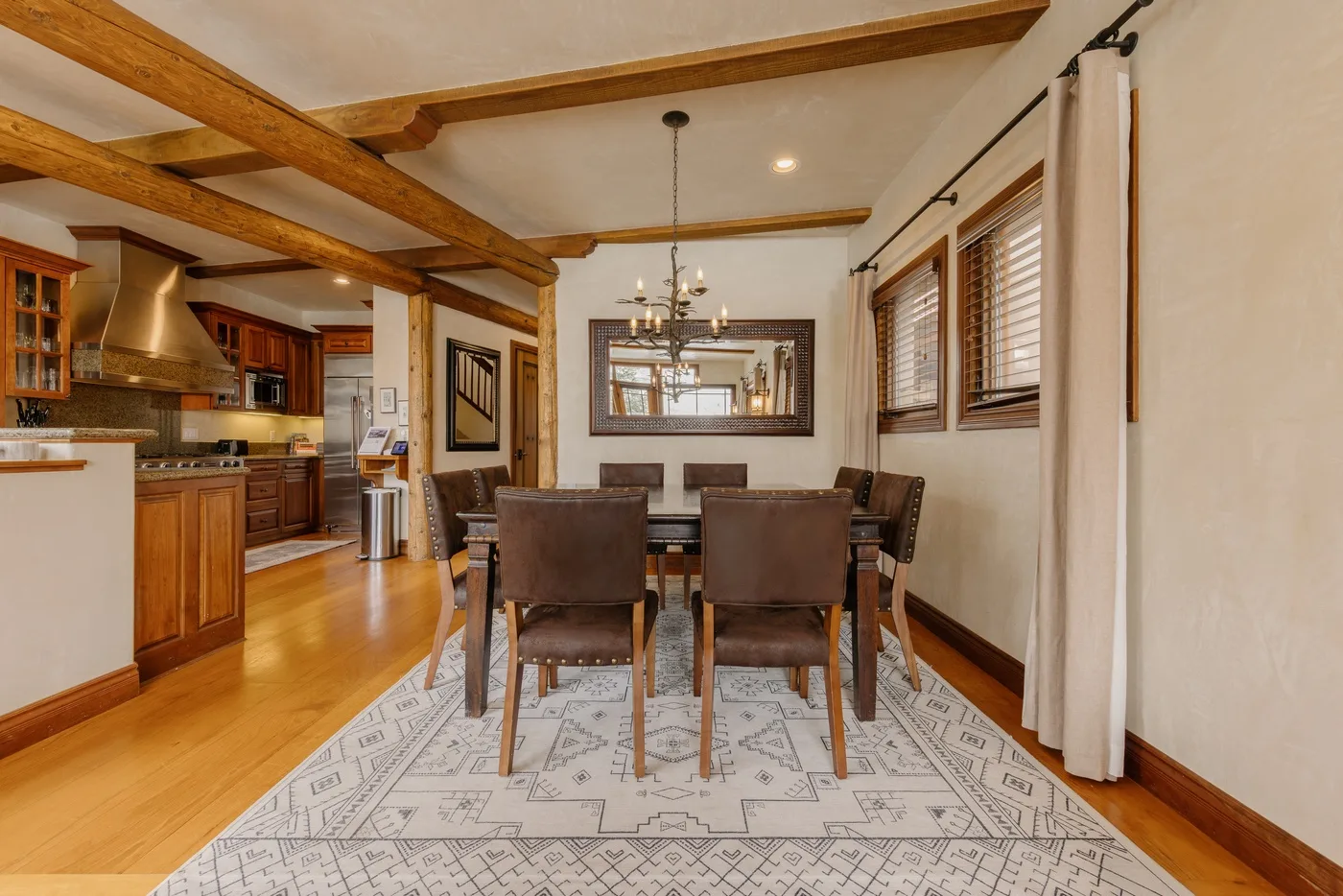 Comedor con mesa y sillas junto a una cocina abierta.