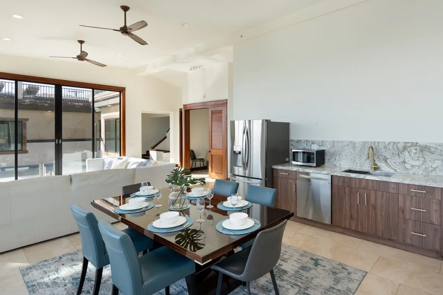 Open-plan dining and kitchen area with a dining table beside the kitchen.
