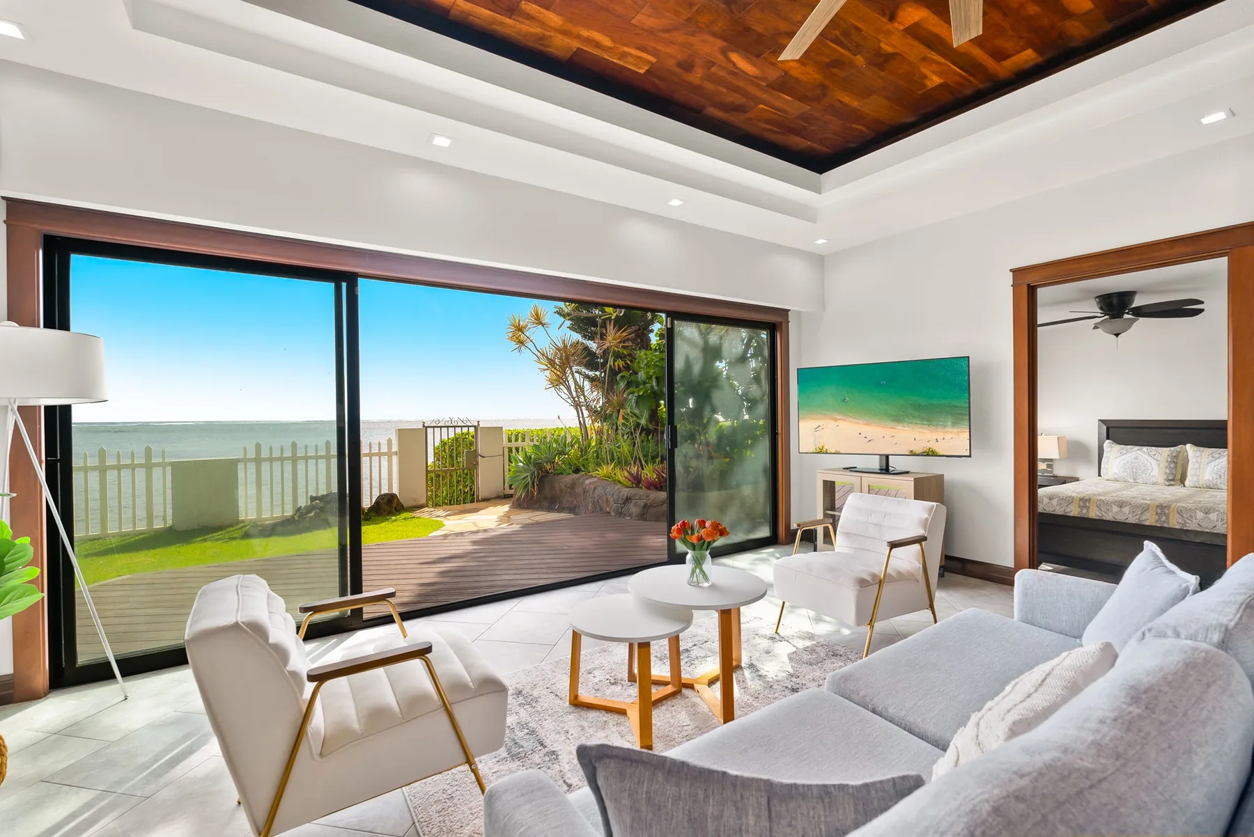 A bright living room with seating beside large sliding glass doors.