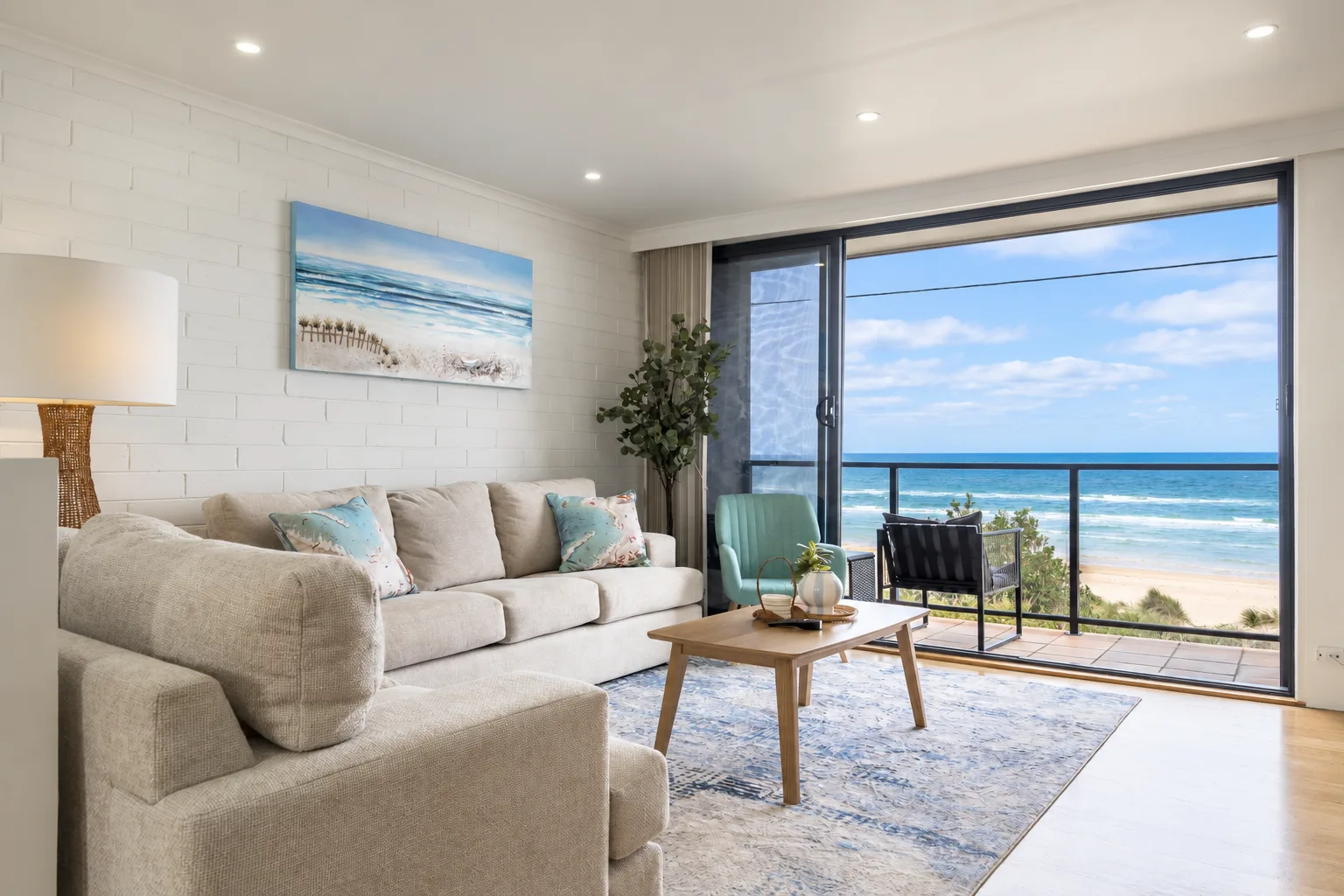 Settle into the living area with the ocean stretching out before you, where generous seating invites you to unwind, catch up or simply watch the waves roll in.