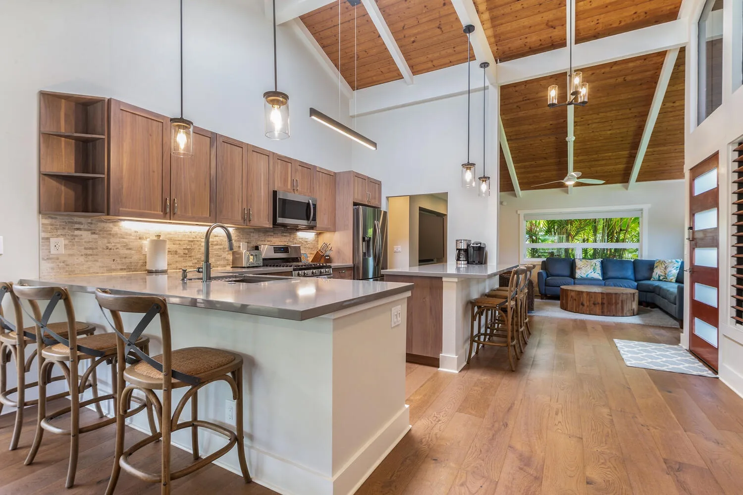 An open-plan kitchen and living area with a counter and seating.