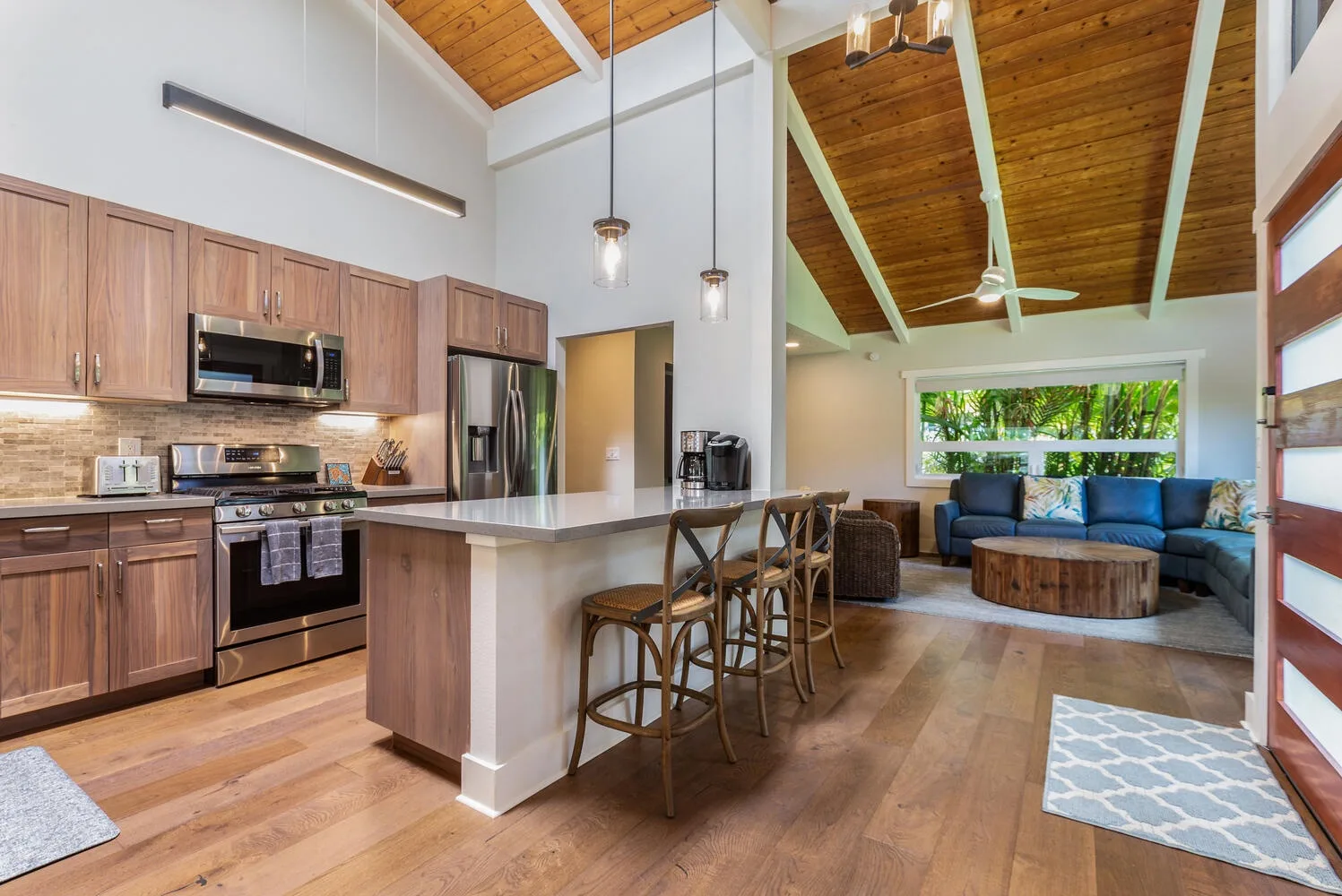 An open-plan kitchen and living area with a breakfast bar and seating.