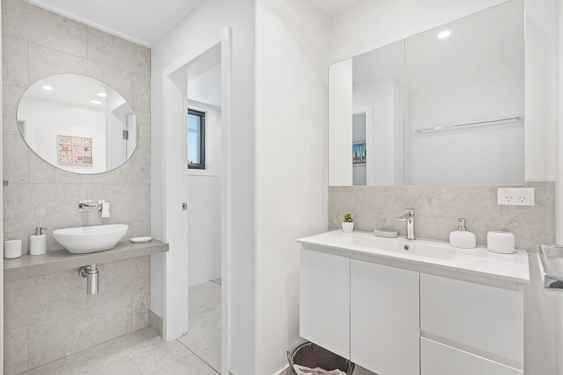 A bright bathroom with a wall mirror above the vanity.