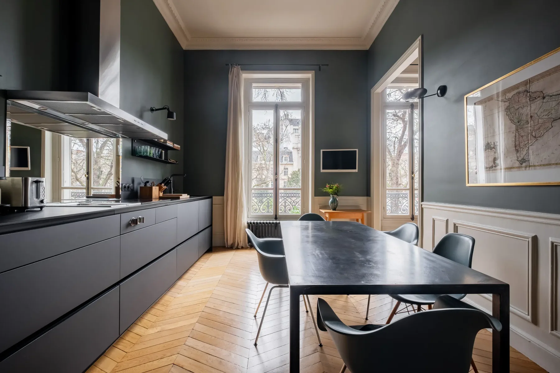 Comedor con una mesa larga y muebles oscuros.