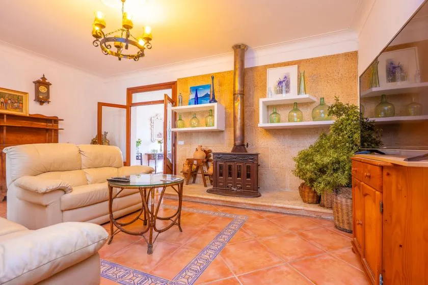 A living room with seating, a wood-burning stove, and open shelving.