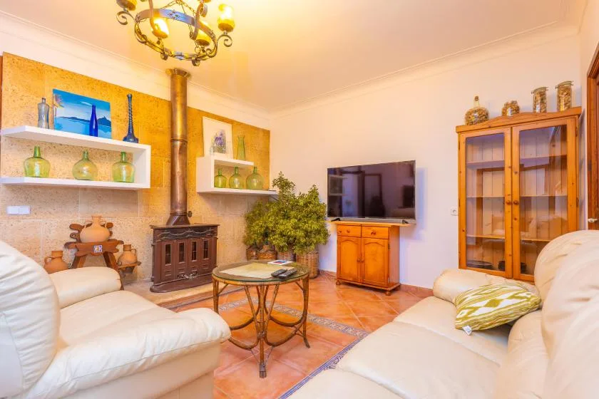 A living room with seating, a coffee table, and a television.