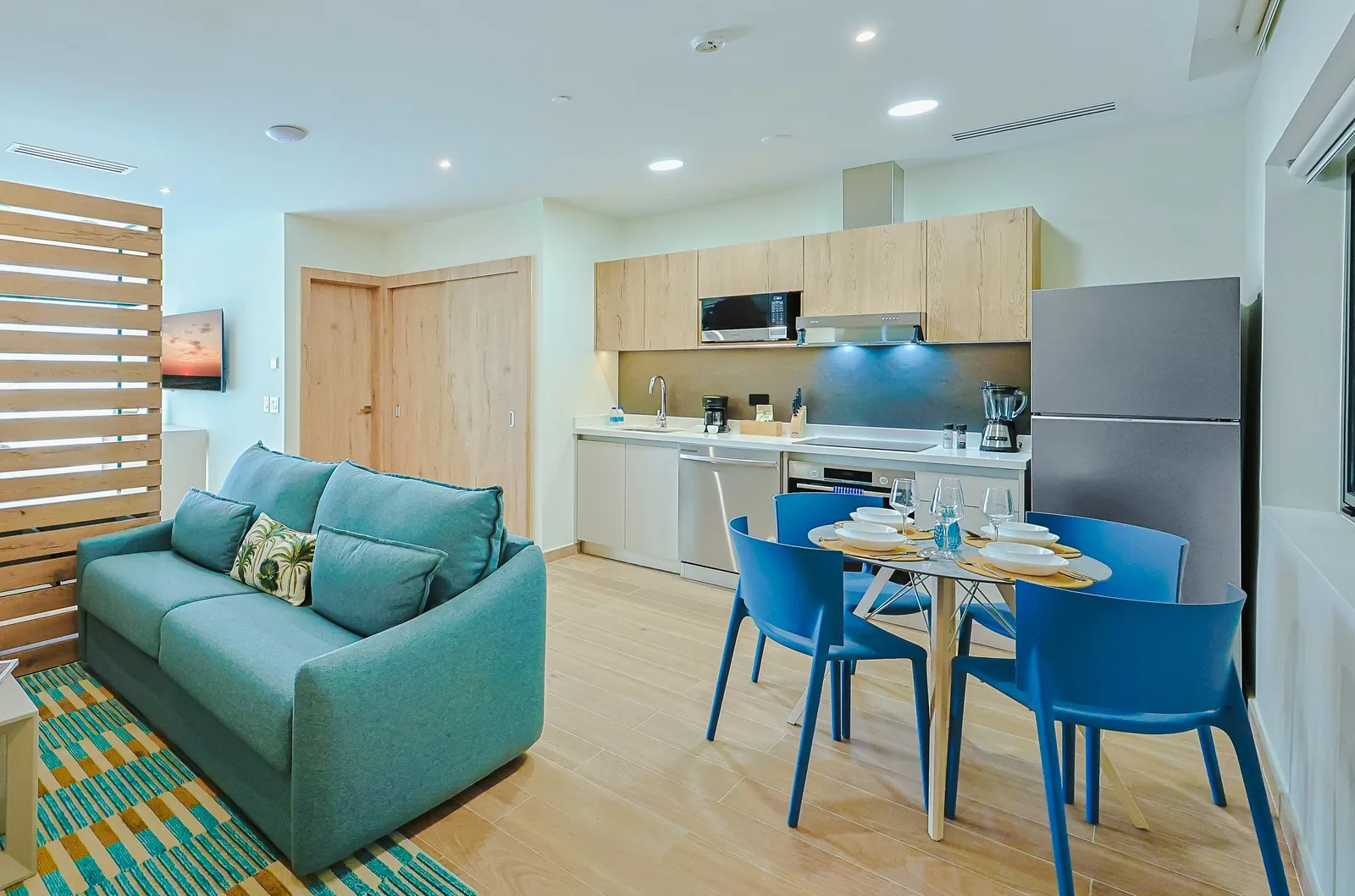 Step into your modern, open-concept retreat, where a welcoming living space flows into a fully equipped kitchen. Your vacation mornings begin at the stylish dining table, surrounded by soothing coastal colors and natural light.