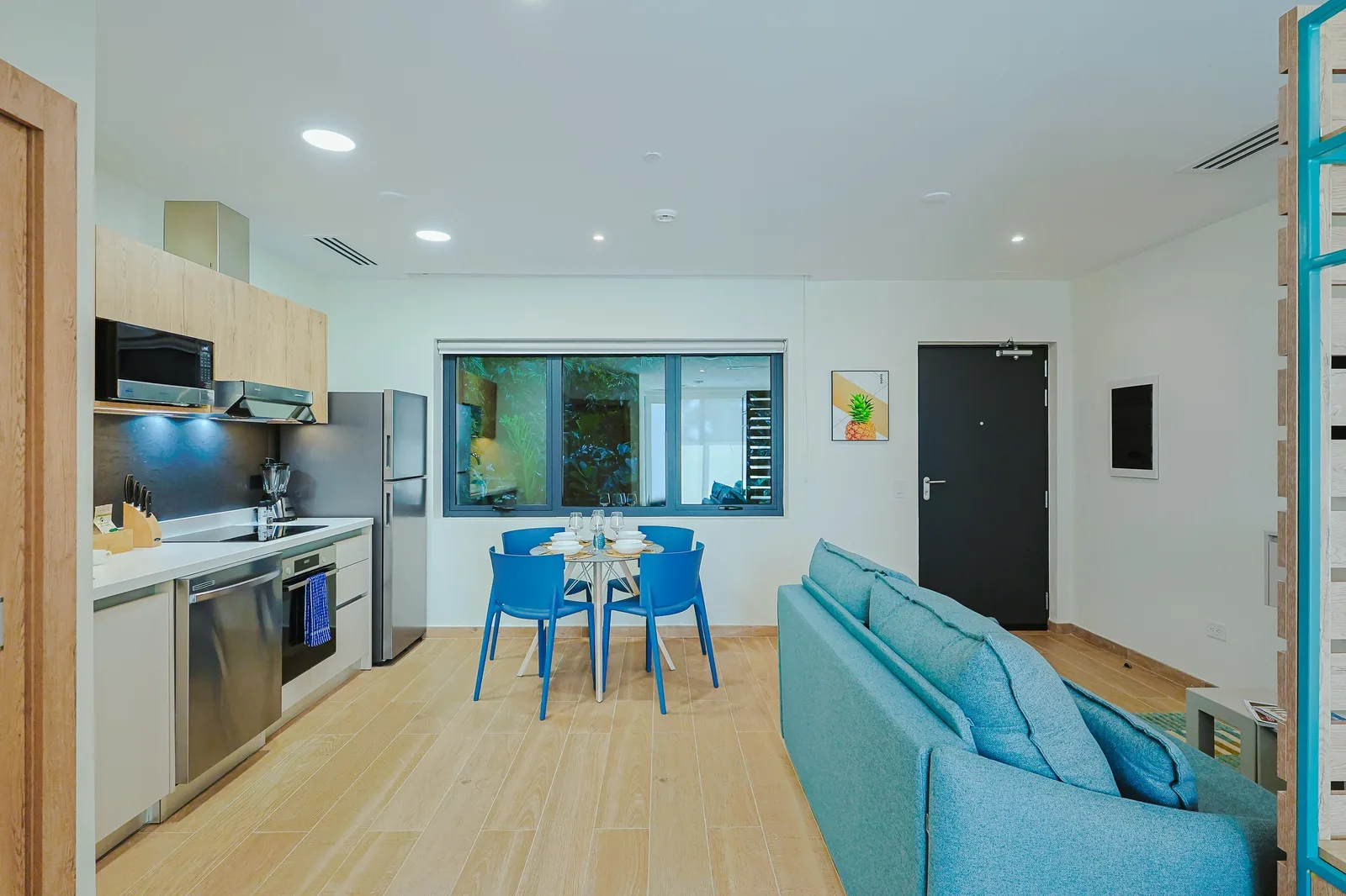 Step into your bright, modern retreat where a fully equipped kitchen and cozy dining nook invite you to savor meals together, while the inviting living area offers the perfect spot to relax after exploring.
