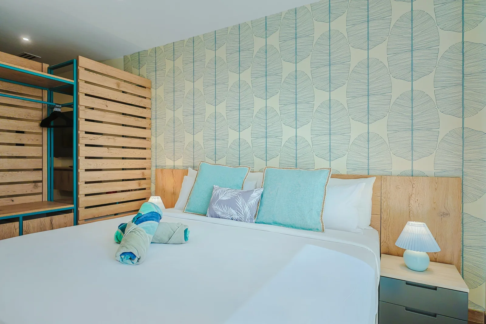Relax in your coastal-inspired retreat with crisp linens, soothing turquoise tones, and natural wood accents creating your perfect seaside sanctuary.