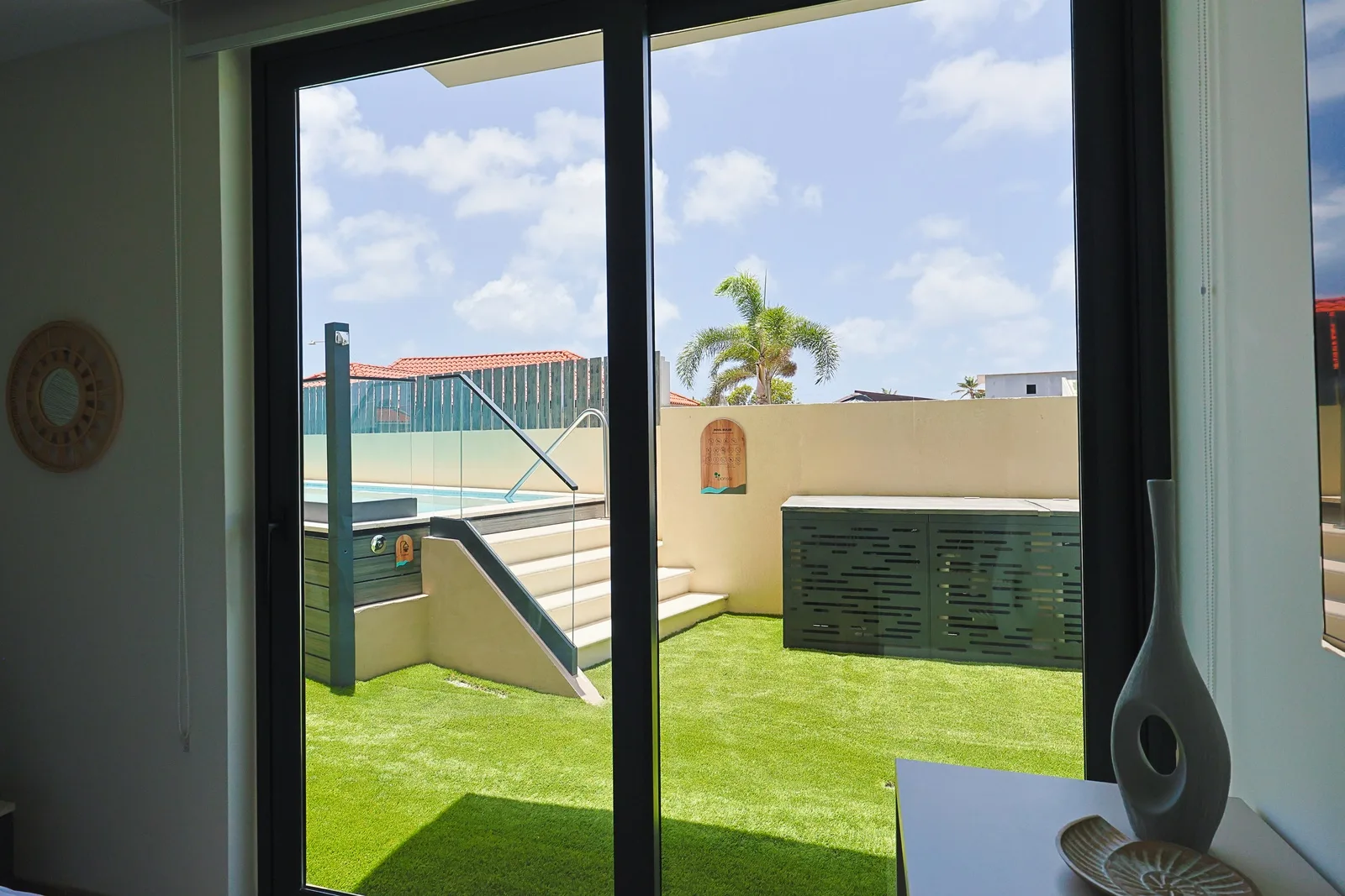 Step outside to your private terrace with lush artificial turf underfoot, pool loungers ready for sunny afternoons, and a sparkling pool just steps away.