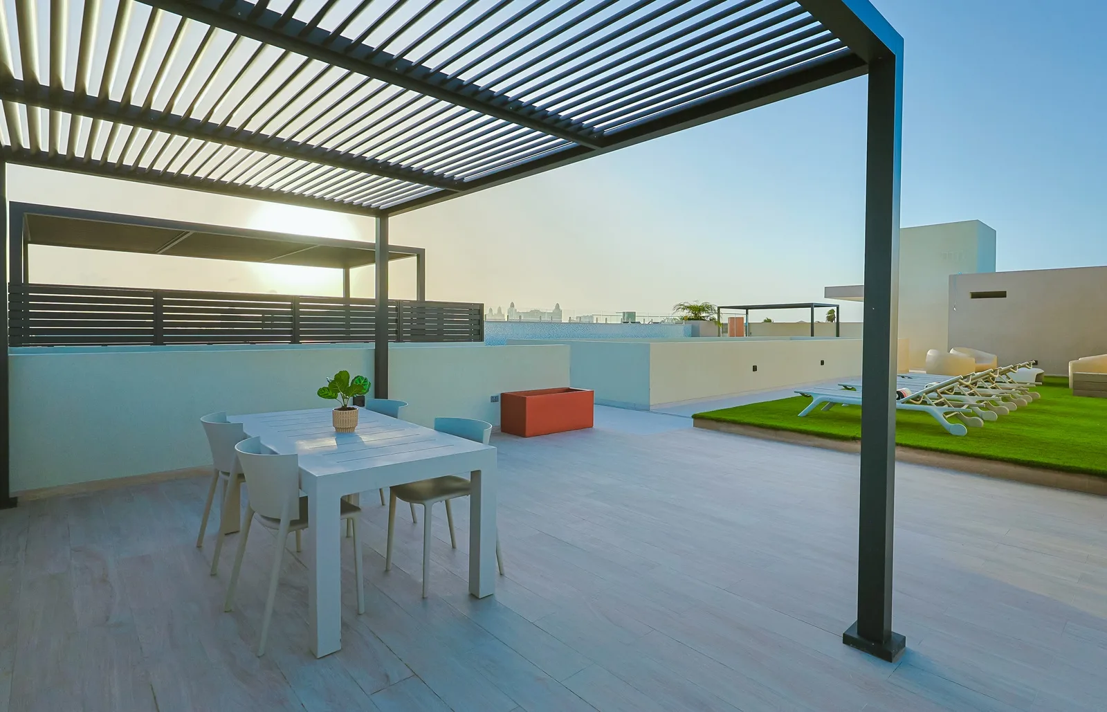The sleek outdoor table offers the perfect spot for morning coffee or sunset cocktails.