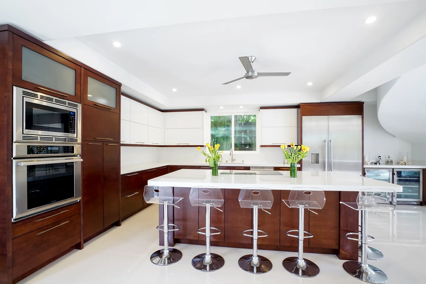 A bright kitchen with a central island and bar seating.