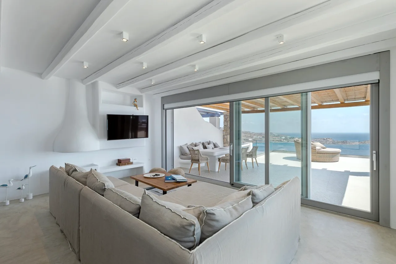 Bright living room with seating and sliding glass doors opening onto a terrace.