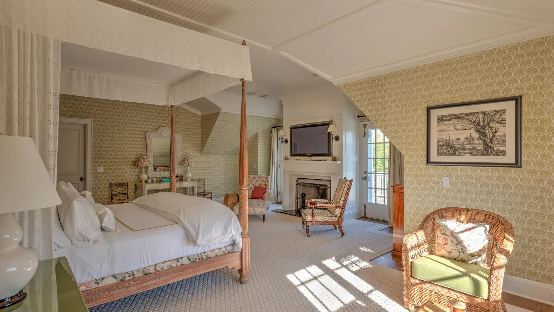 Dormitorio con cama con dosel, asientos y chimenea.
