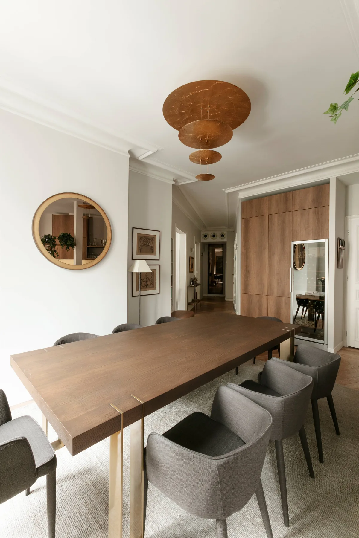 Un comedor con una mesa larga de madera y asientos tapizados.