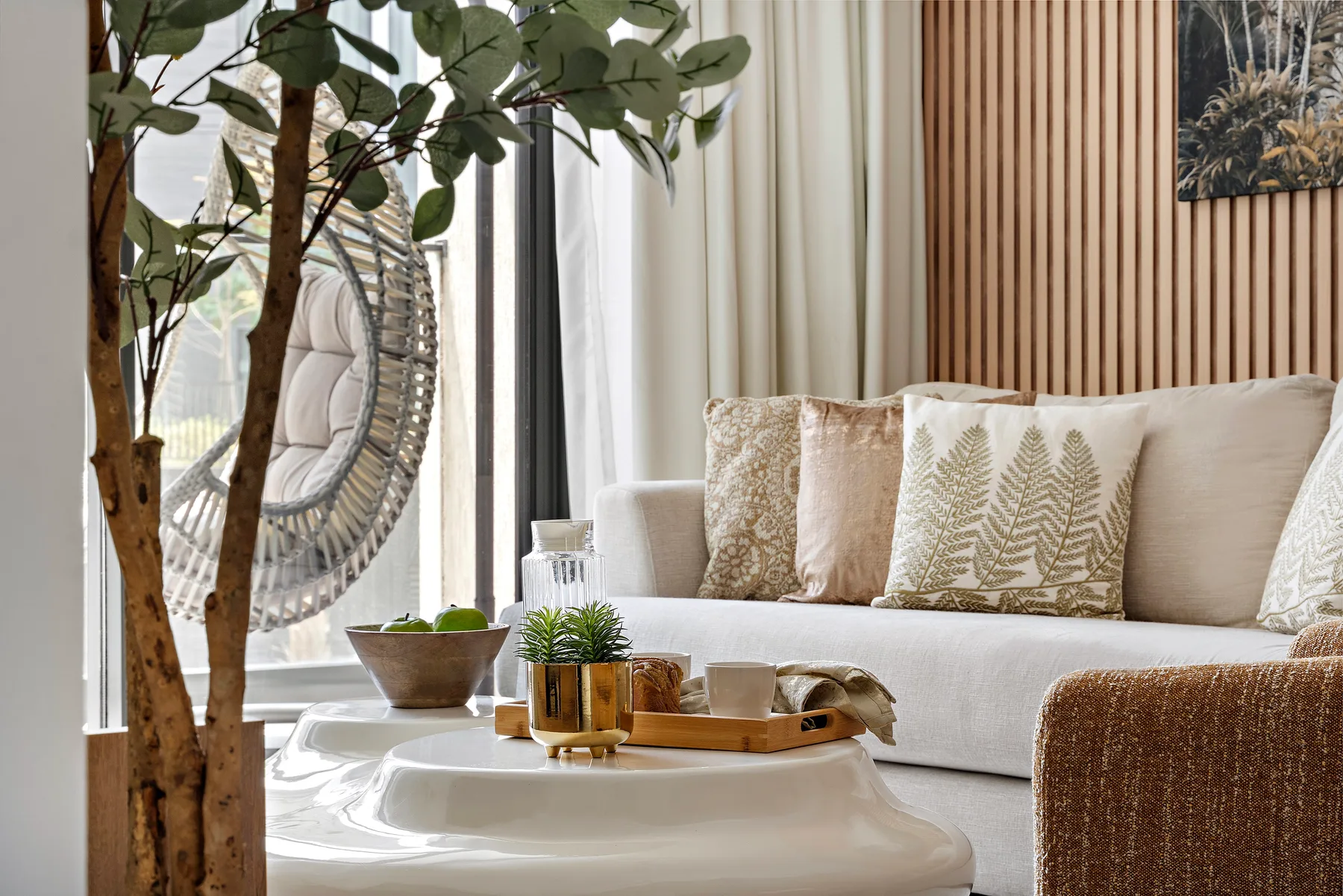 A bright living room with a light-colored sofa and a low coffee table.