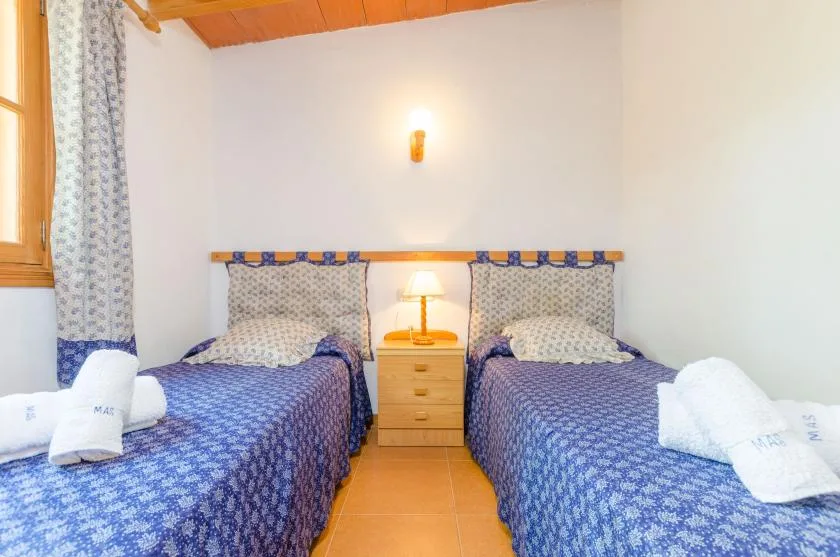 A twin bedroom with two beds and a bedside table between them.