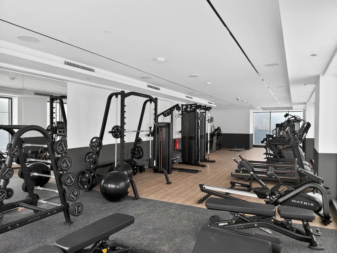 Una sala de fitness con equipo de pesas y máquinas de ejercicio.